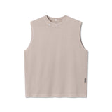 flatlay Tech Essential Relaxed Cutoff sleeveless tank in faded chai, front view