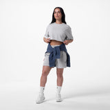 Heather grey relaxed tech tee worn with grey shorts and navy jacket tied at waist, white socks and sneakers