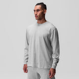 Tech Essential Relaxed Long Sleeve in heather grey, worn by model in front pose