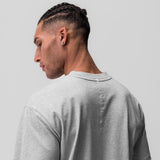 Tech Essential Relaxed Tee in heather grey, worn by model shown from back