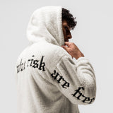 Sherpa Recovery Hoodie in ivory cream with black text, worn by model in profile pose