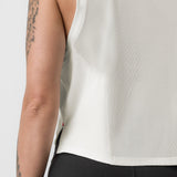 Ivory cream cropped training tank on model, side view showing fit and tattooed arm