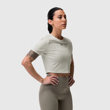 Ivory cream cropped tee worn by model, paired with olive high-waist leggings, side profile pose