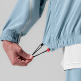 Aerotex™ Track Jacket in Light Sky, model wearing jacket with drawstring detail visible