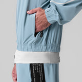 Aerotex™ Track Jacket in Light Sky, model wearing jacket with hand in pocket, detail view