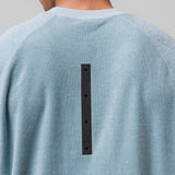 Towel Terry Cutoff in light sky worn by model, back view showing black button detail