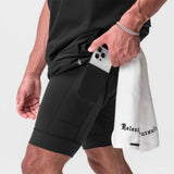 Tetra-Lite 7" Liner Short in black with white bracket, worn by model holding phone in pocket
