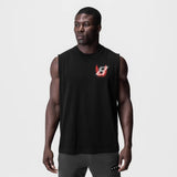 Black Tech Essential Relaxed Cutoff tank top with red logo, worn by model, front view
