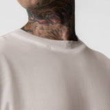 Tech Essential Relaxed Tee in Faded Chai worn by model, close-up of neckline and shoulders