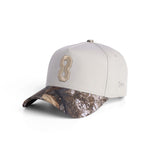 flatlay New Era 9Forty A-Frame Hat in stone and realtree camo with embroidered 8 logo, angled view