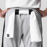 Cuffed training jogger in slate grey with white towel detail, worn by model