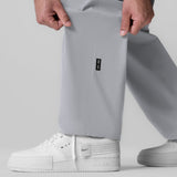 Tetra-Lite Field Pant in slate grey worn with white sneakers, front view