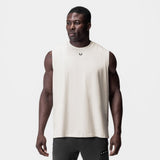 Tech Essential Relaxed Cutoff tank in stone, worn by model, front view
