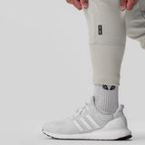 Tech-Terry Cargo High Rib Jogger in stone worn with white socks and sneakers, leg detail view
