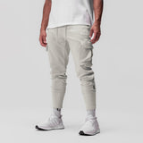 Tech-Terry Cargo High Rib Jogger in stone, modeled from the side, paired with white socks and sneakers