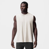 Tech Essential Relaxed Cutoff tank top in stone white, worn by model, front view