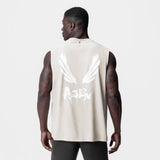 Tech Essential Relaxed Cutoff tank in stone with white brush wings logo, back view on model
