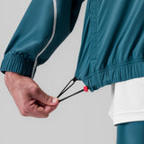 Aerotex Track Jacket in Storm blue being worn, detail of adjustable cuff and drawstring
