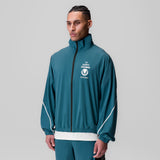 Aerotex Track Jacket in teal with white trim, worn by model facing forward