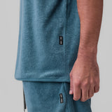 Towel Terry Cutoff in storm blue worn by model, side detail view showing label