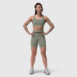 Lycra 3-in-1 biker short in sage, worn by model standing against white background