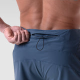 Revolutional® Board Short in storm blue, worn by model showing waistband and drawstring detail