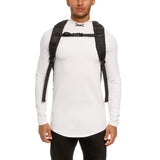 Modular Everyday Pack in black, worn on model's back with white long-sleeve shirt