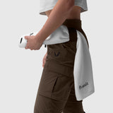 Tetra-Lite Cargo High Rib Jogger in Dark Earth, worn with white towel, side view