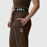 W036 Ripstop Relaxed Track Pant in Dark Earth, worn by model showing side view with hand in pocket