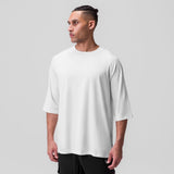 White Supima® 3/4-sleeve oversized tee worn by model, side profile view