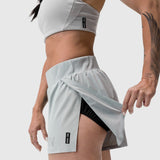 Aerotex Side Split Run Short in slate grey, worn by model showing side split detail and black liner shorts