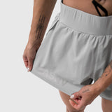 Aerotex Side Split Run Short in Slate Grey worn by model, front view showing reflective logo detail