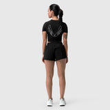 W037 Tetra-Lite Linerless Short in black, worn by model from behind showing wing graphic on cropped tee