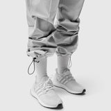 W036 Ripstop Relaxed Track Pant in slate grey, worn with white socks and sneakers, lower body view