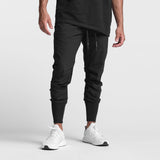 Black Tetra-Lite High Rib Jogger worn by model with white sneakers, front view