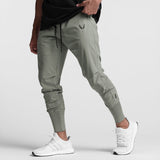Tetra-Lite High Rib Jogger in sage worn by model with white sneakers, side view