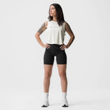Ivory cream cropped training tank on model, paired with black shorts and white socks, front facing