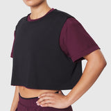 Reversible crop tee in merlot and black worn by model, front view