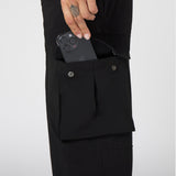 W100 2-in-1 Convertible Pant in Black, worn with phone in pocket